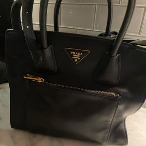 Black leather Prada tote bag.